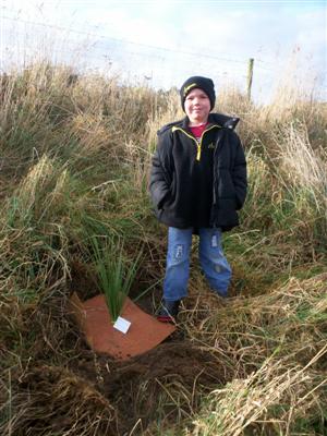 Here is  Jared planting
his tree.